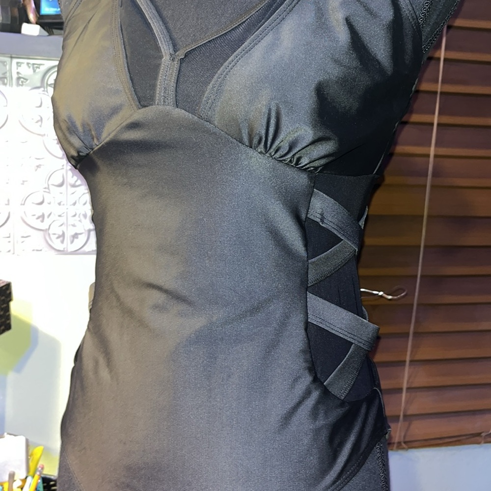 #128-NWOT Sexy One piece Black swim suit with slimming sides, never worn